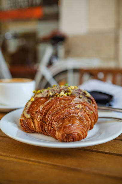 istock Breakfast time with croissant, coffee, and magazine 1616355377