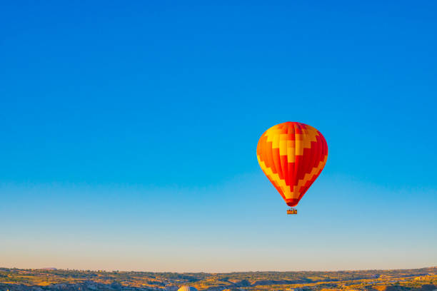 istock Hot air balloon at sunrise 1616380686