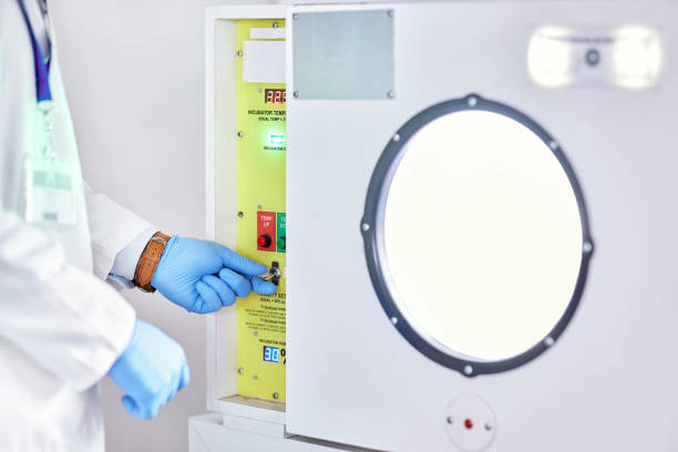 istock Laboratory, test and hands on button on machine for science research, experiment or innovation. Lab, scientist hand with glove and exam safety in technology for medical engineering and manufacturing. 1616389525