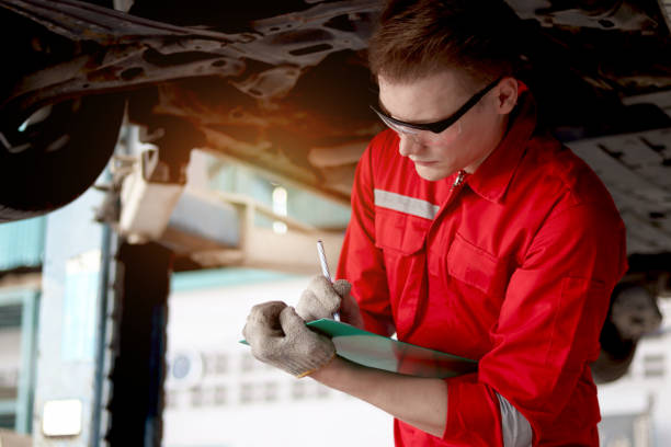 istock Mechanic in red uniform work with lifted vehicle, inspect car engine system underbody, auto mechanic check wheel at garage, technician check and maintenance customer car automobile at repair service. 1616392428