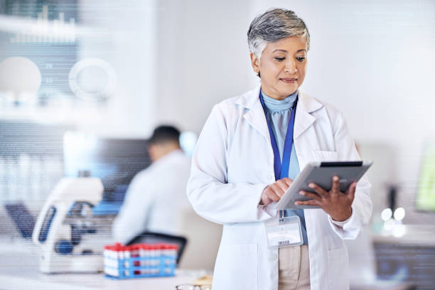 istock Senior scientist, woman with tablet and overlay, code with digital science data for medical research in lab. Biotech, female doctor with scientific experiment results and analytics from investigation 1616394078