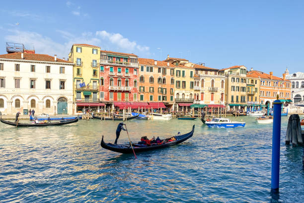 Gondola with tourists on the Grand Canal in Venice - Italy stock photo