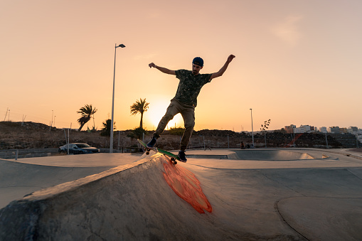 young man skating at sunset
