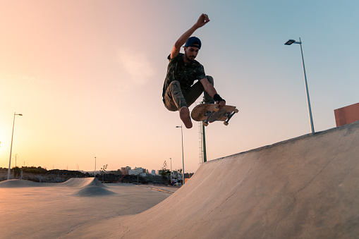 young man skating at sunset