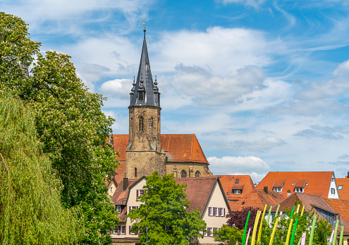 Steeple of the evangelical church and some houses in Öhringen, a town in the Hohenlohe district in Southern Germany