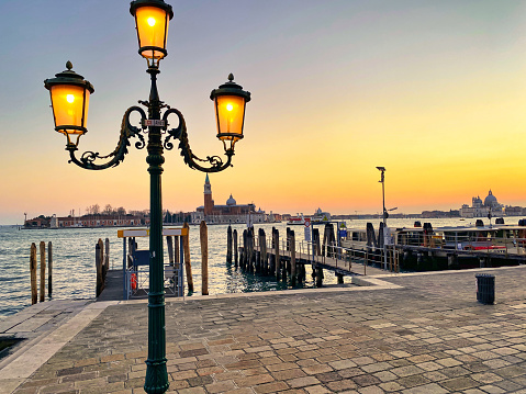 Venice, Italy, at sunset, street lamp on the pier. Italian landscape.