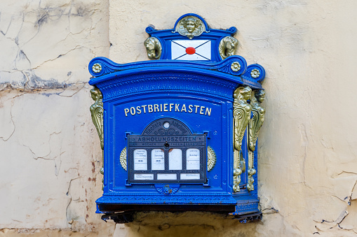 Glucksburg, Germany, July 5 2020, blue golden historical postbox in gluecksburg