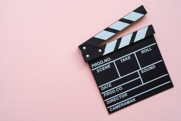 istock Cinema clapperboard on pink background with copy space. 1616448203