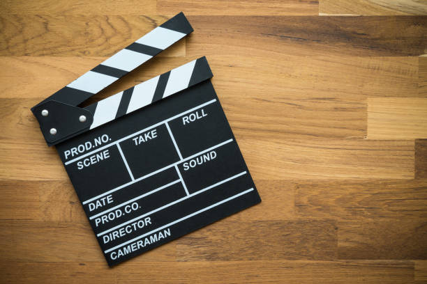 istock Cinema clapperboard on wooden background. 1616448216