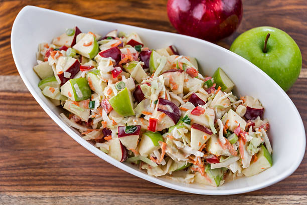 Coleslaw with green and red apples A bowl of fresh-made coleslaw with green and red apples. coleslaw stock pictures, royalty-free photos & images