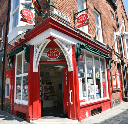This Post Office is housed in a striking red painted building and occupies a prominent site right near the crossroads of Bailgate and Eastgate, in Lincoln, Lincolnshire.