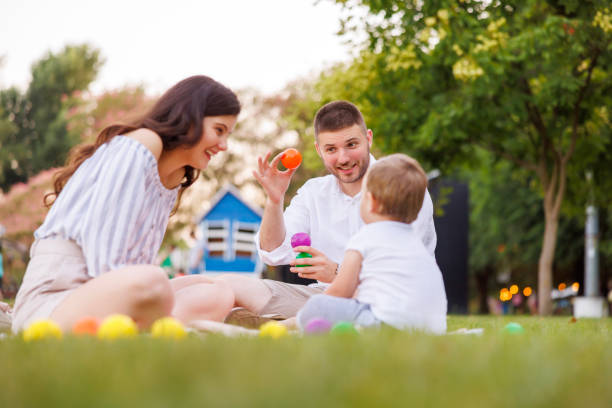 istock Young parents playing with their kid while having picnic 1616493053