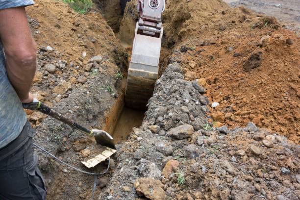 istock laying fiber optic cable with a molding cutter 1616493080