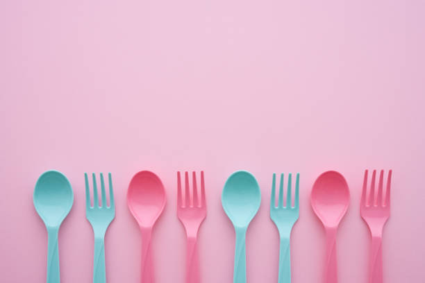 istock Flat lay of pastel pink blue spoon and fork on pink background, minimal simple style. 1616498809