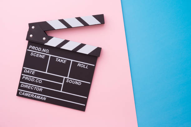 istock Cinema clapperboard on pink blue background copy space. 1616543145