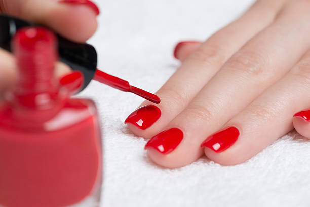 istock A woman getting a manicure with red nail polish 161654537