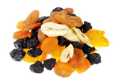Dried fruit isolated on white. Includes apricot, apple and prune.