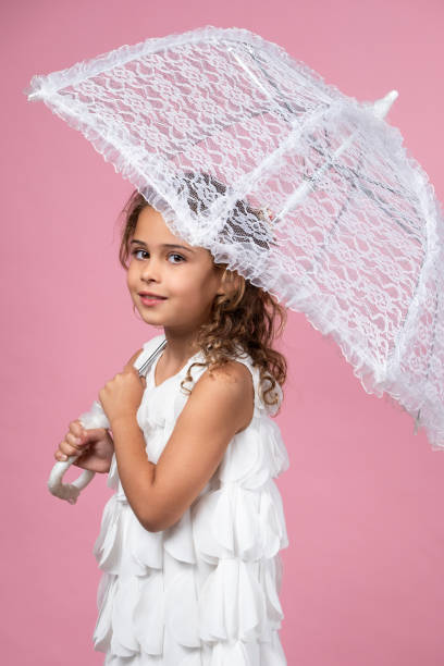 Studio shot of happy girl with umbrella