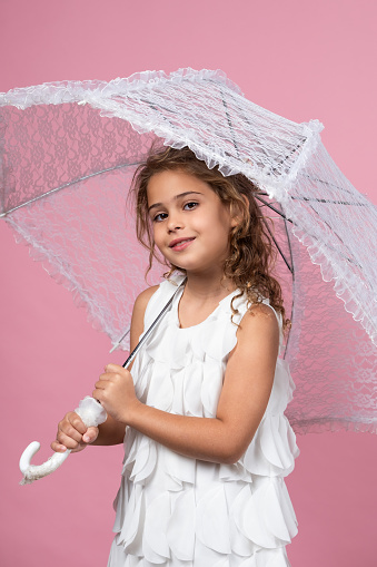 Studio shot of happy girl with umbrella