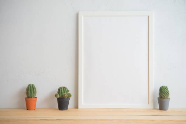 istock Photo frame and cactus pots mockup with white wall background. 1616569519