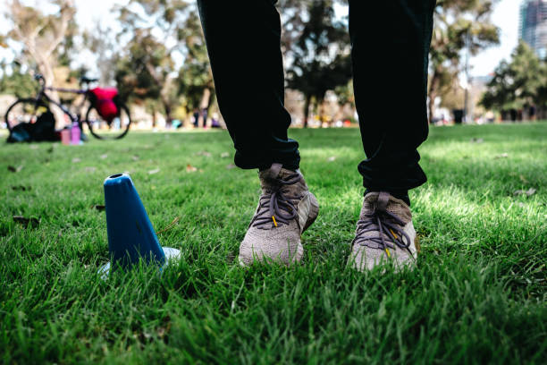 Low section of a athlete exercising at public park