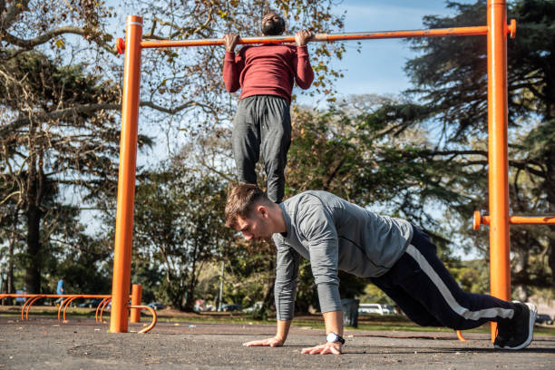 istock Young men doing exercises on the public park 1616576219