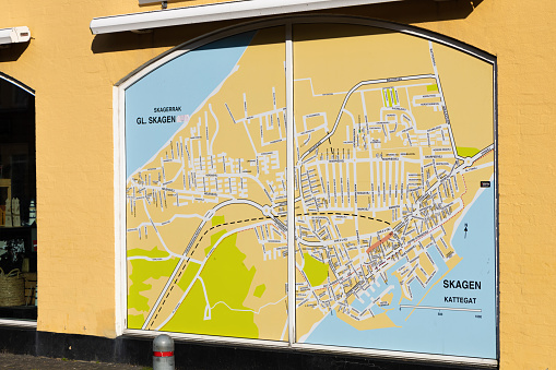 A large map of the city of Skagen on the wall of the building. Skagen, Denmark - August 16, 2023.