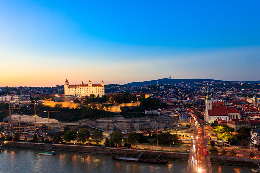 Bratislava, Slovakia - October 7, 2022: View of Bratislava castle, old town and the Danube river from observation deck the bridge in Bratislava, Slovakia at night