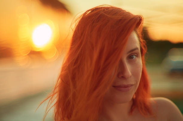 Close up portrait of a beautiful red haired women. Photographed at sunset with golden light