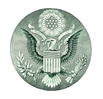 The Great Seal of the United States, featuromg an eagle grasping an olive branch in one talon, representing peace, and arrows in the other, symbolizing strength. The eagle's beak holds a banner with the motto 