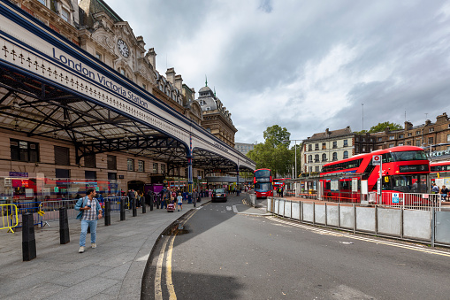London, United Kingdom - Aug 14, 2023: Exterior view of Victoria railway station in central London. It has a traditional large glass roofed canopy outside the entrance.