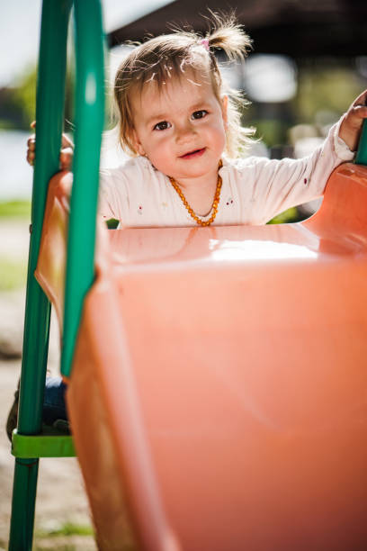 istock Small girl playing at playground 1616610715