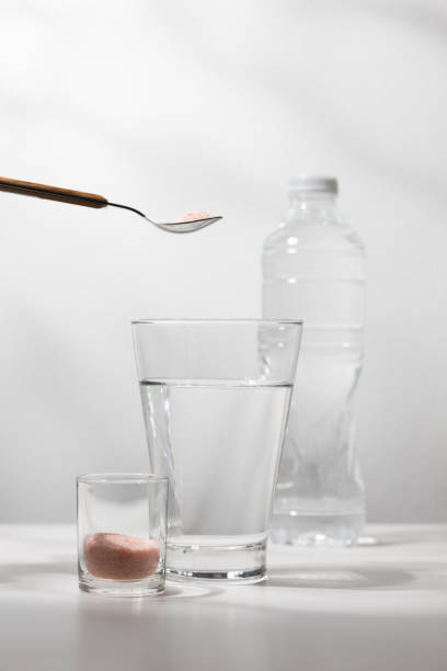 istock Mix pink himalayan mineral salt to drinking water. 1616611653