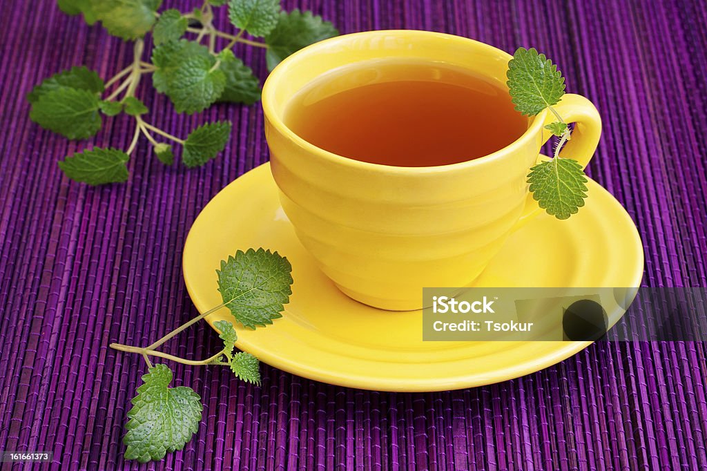 Herbal Tea Herbal Tea with a fresh lemon balm leaves on a table. Herbal Tea Stock Photo