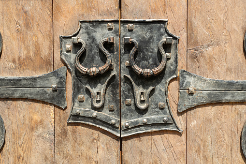 Metal element of an antique wooden door. High quality photo
