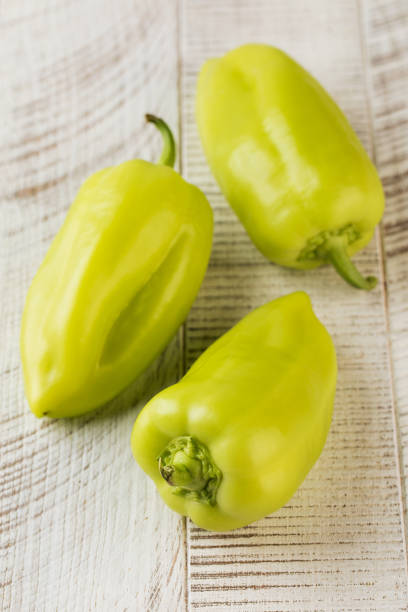 istock Green peppers on a white wooden table. Vegetables, harvesting. 1616637502