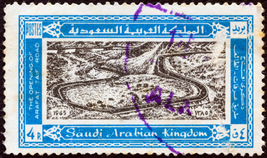 SAUDI ARABIA - CIRCA 1965: A stamp printed in Saudi Arabia issued for the opening of highway from Mecca to Tayif shows the highway, Hejaz Mountains.