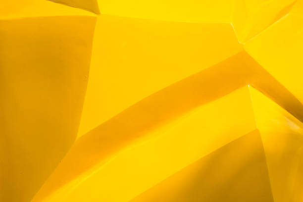 istock Yellow plastic detail surface background texture of toy. 1616642502