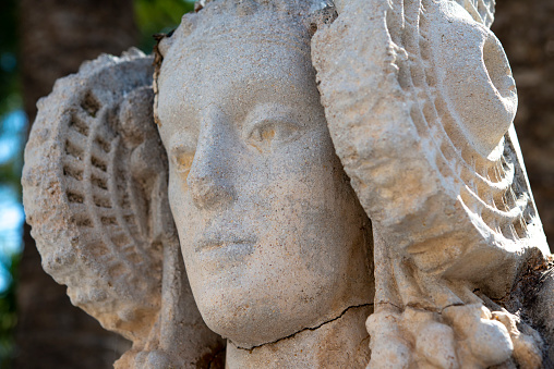 White marble statue of angel in ornamental garden