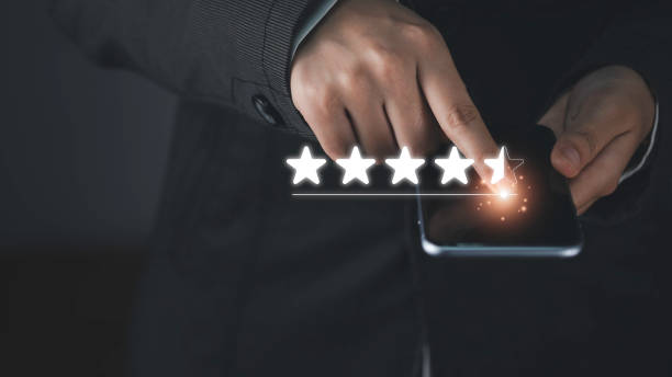 istock Customer service evaluation and satisfaction survey concepts. Customer hand hold smartphone and touching on screen with gold five star rating excellent feedback icon, Rated a very good review. 1616648414