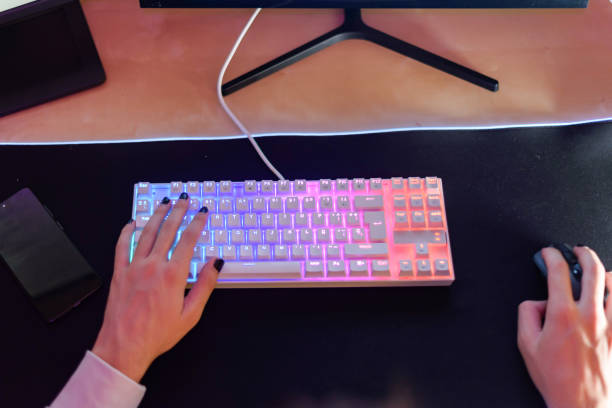 istock Unrecognizable person sitting with hand on keyboard and using mouse 1616658734