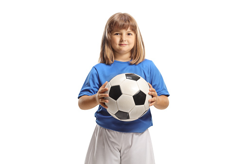 Girl in football clothes holding a ball isolated on white background