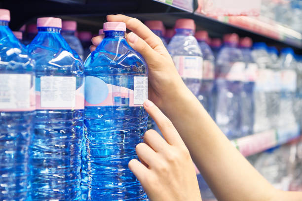 istock Drinking water in hand at shop 1616674300