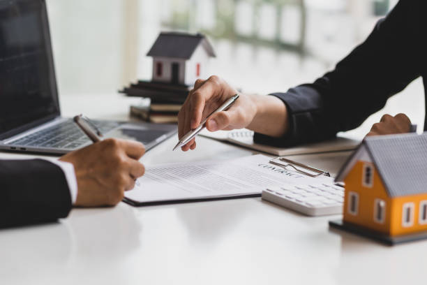istock Real estate agent holding pen pointing at contract document for client to sign home purchase agreement, Signing a home insurance contract. 1616681511