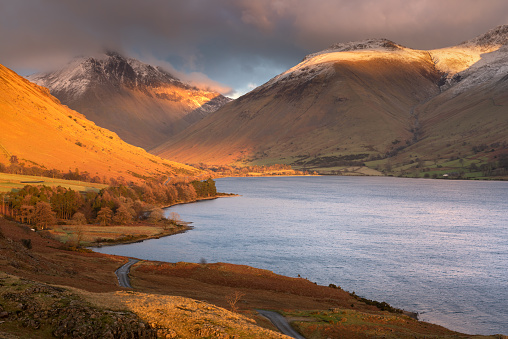 Dramatic Winter late evening sunlight illuminating the Western Cumbrian mountains at Wastwater in The Lake District, UK.