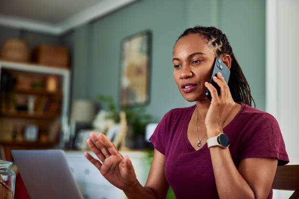 istock A busy African female freelancer having a phone call while working on a laptop. 1616714168