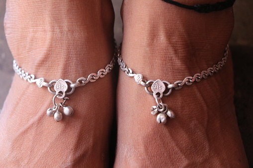 Pair of women's legs with silver anklets or payal on their feet