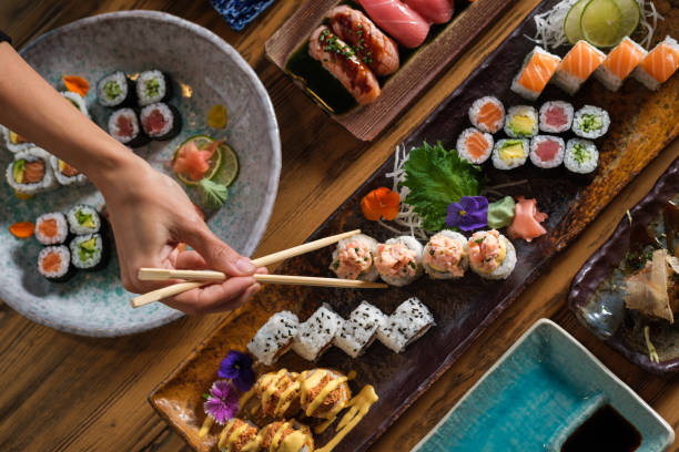 istock Unrecognizable person eating sushi 1616720864