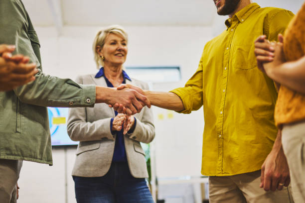 istock Low angle view of business executives shaking hands in office 1616721641