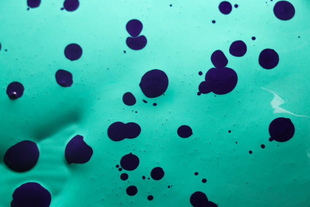 istock abstract background with spots of violet paint on a turquoise background 1616721670